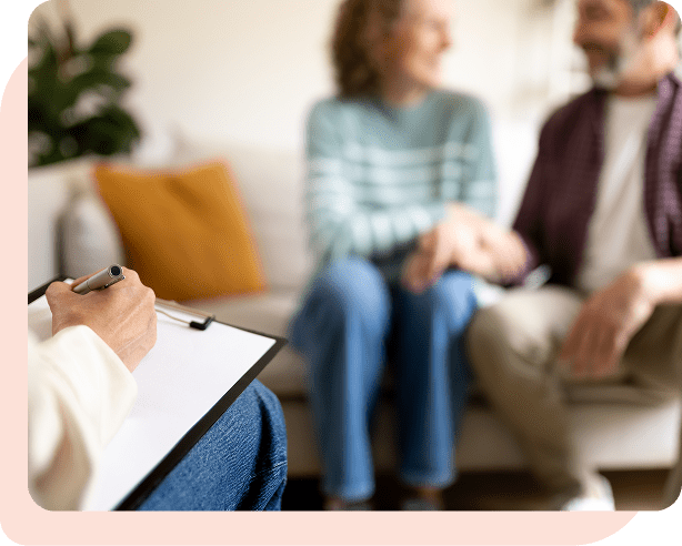 A couple holding hands and smiling during a faith-based Christian marriage counseling session in Las Vegas with therapist Dr. Belle, LMFT