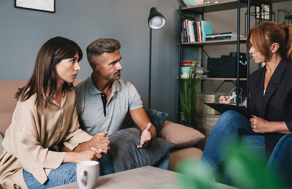 A young couple expressing their feelings during a couples therapy session.
