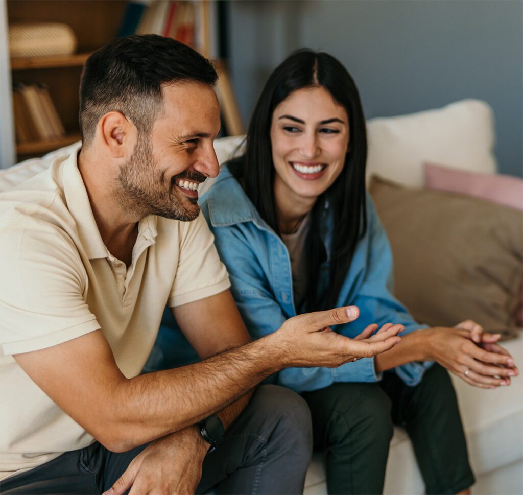 Why choose Dr. Belle for couples intensive and therapy with couple smiling while talking to Dr. Belle.