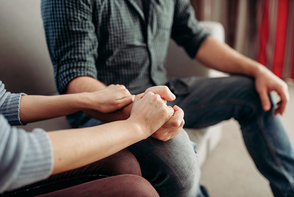 Therapist holding hands with a couple during a couples therapy session in Las Vegas, NV – Dr. Belle, PhD, LMFT